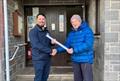 Solway YC member, Ian Purkis (right) hands the Building Standards (Scotland) approved plans for the project to Paul Widdowson, Director of South West Trades © Robert Dinwiddie