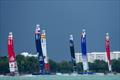 Teams take part in a practice session as the storm clouds gather over the city ahead of the Singapore Sail Grand Prix  © Bob Martin/SailGP