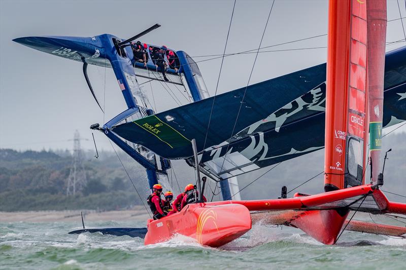 China SailGP Team sails past as the United States SailGP Team's F50 capsizes slowly after a turn during race one. Race Day  - Cowes, Day 2, August 11, 2019 photo copyright Ian Roman for SailGP taken at  and featuring the F50 class