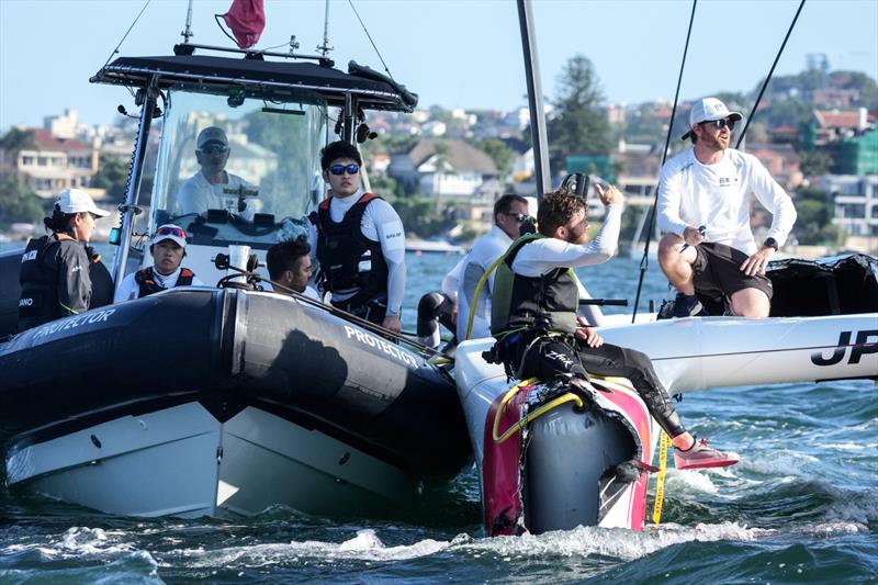 Japan SailGP Team members helmed by Nathan Outterridge sit on their damaged F50 catamaran after a collision with Great Britain SailGP Team  photo copyright Bob Martin/SailGP taken at Woollahra Sailing Club and featuring the F50 class