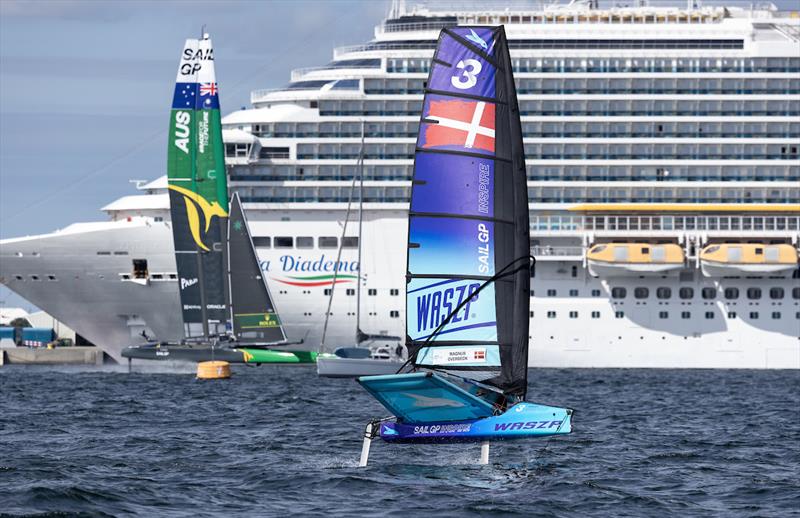 The Australia SailGP Team F50 catamaran and the Costa Diadema cruise ship are seen in the background as a young sailor takes part in the Inspire Racing x WASZP program on Race Day 2 of the ROCKWOOL Denmark Sail Grand Prix in Copenhagen, Denmark photo copyright Felix Diemer for SailGP taken at  and featuring the F50 class