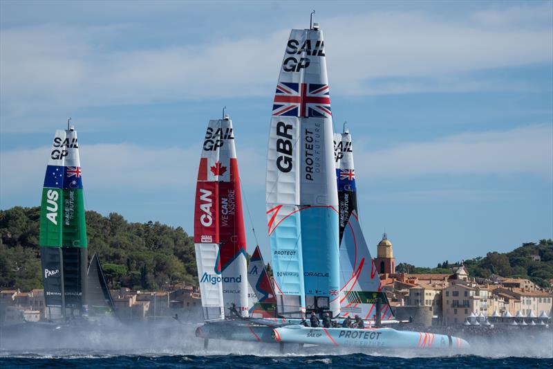 Australia SailGP Team, Canada SailGP Team , and Great Britain SailGP Team sails past the bell tower and old town of Saint Tropez on Race Day 1 of the Range Rover France Sail Grand Prix in Saint Tropez, photo copyright Bob Martin/SailGP taken at Société Nautique de Saint-Tropez and featuring the F50 class