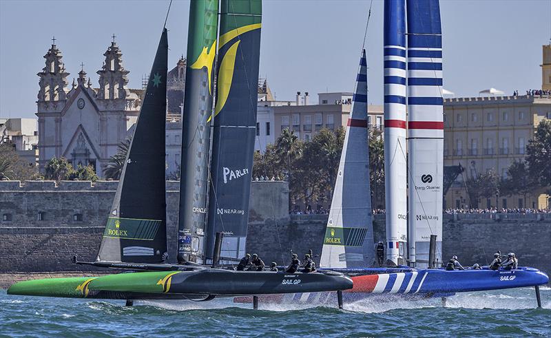 Australia SailGP Team helmed by Tom Slingsby and France SailGP Team helmed by Quentin Delapierre sail past the Cadiz Cathedral on Race Day 1 of the Spain Sail Grand Prix in Cadiz, Andalusia, Spain. 24th September photo copyright Felix Diemer for SailGP taken at  and featuring the F50 class
