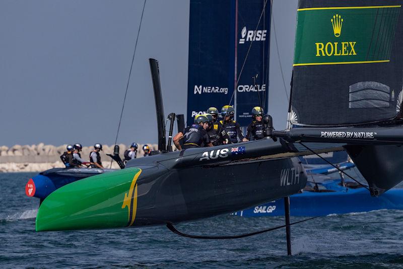 Australia SailGP Team helmed by Tom Slingsby in action as they sail past USA SailGP Team during a practice session ahead of the Dubai Sail Grand Prix presented by P&O Marinas in Dubai, United Arab Emirates photo copyright Felix Diemer for SailGP taken at  and featuring the F50 class