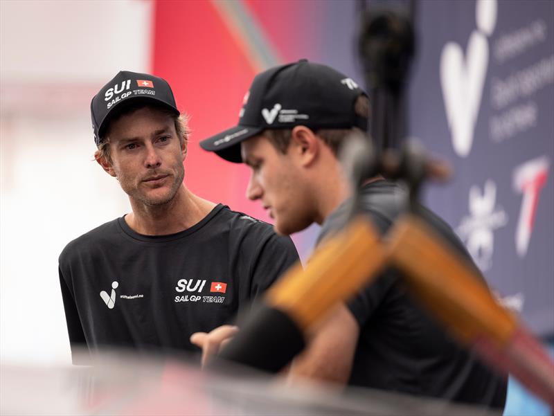 Sebastien Schneiter, co-driver and strategist of Switzerland SailGP Team, talks with new team member Will Ryan of the Switzerland SailGP Team in the technical area ahead of the KPMG Australia Sail Grand Prix in Sydney, Australia. Tuesday 14th February photo copyright Felix Diemer for SailGP taken at  and featuring the F50 class