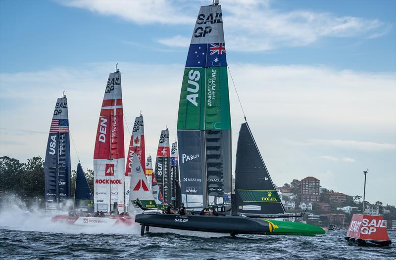 The fleet with Australia SailGP Team in the foreground cross the start on Race Day 1 of the KPMG Australia Sail Grand Prix photo copyright Bob Martin for SailGP taken at Royal Sydney Yacht Squadron and featuring the F50 class