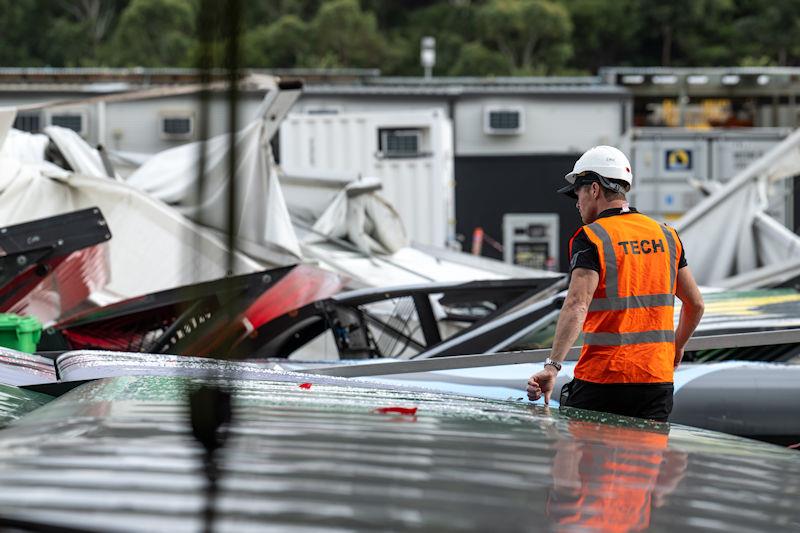 Tom Slingsby, CEO and driver of Australia SailGP Team, inspects the damage in the technical area following the storm after racing on Race Day 1 of the KPMG Australia Sail Grand Prix in Sydney, Australia photo copyright Ricardo Pinto for SailGP taken at  and featuring the F50 class