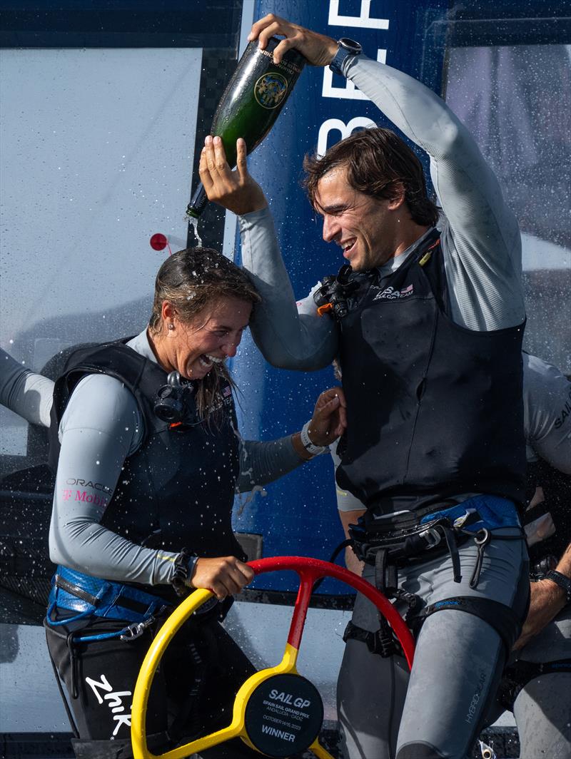 Mac Agnese, grinder of USA SailGP Team, sprays Barons De Rothschild Champagne on Erika Reineke, strategist of USA SailGP Team, as they USA SailGP Team celebrate onboard after winning the Spain Sail Grand Prix in Cadiz, Spain photo copyright Bob Martin for SailGP taken at  and featuring the F50 class