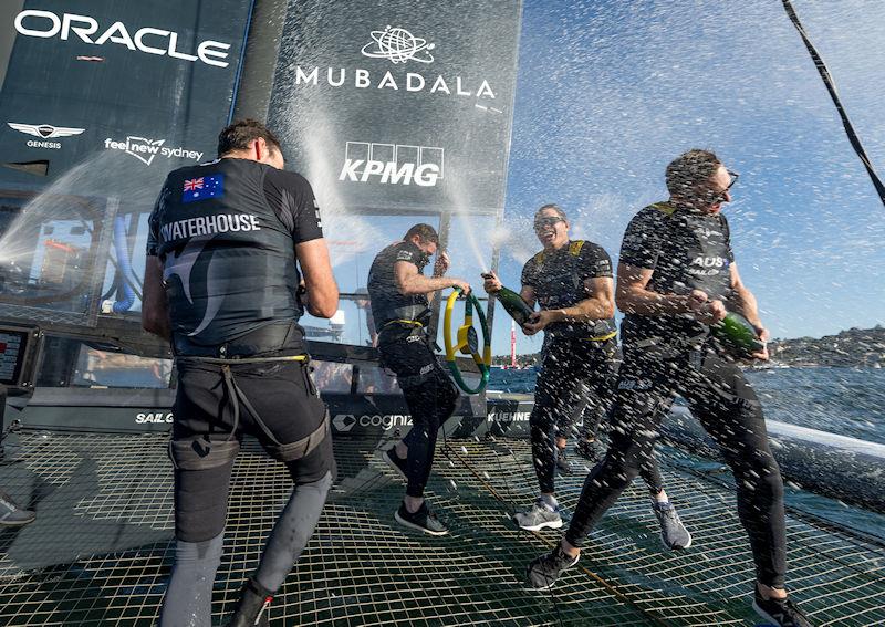 Sam Newton sprays Barons De Rothschild Champagne on team-mates Tom Slingsby, Jason Waterhouse and Kyle Langfordafter they won the KPMG Australia Sail Grand Prix in Sydney, Australia photo copyright Ricardo Pinto for SailGP taken at  and featuring the F50 class