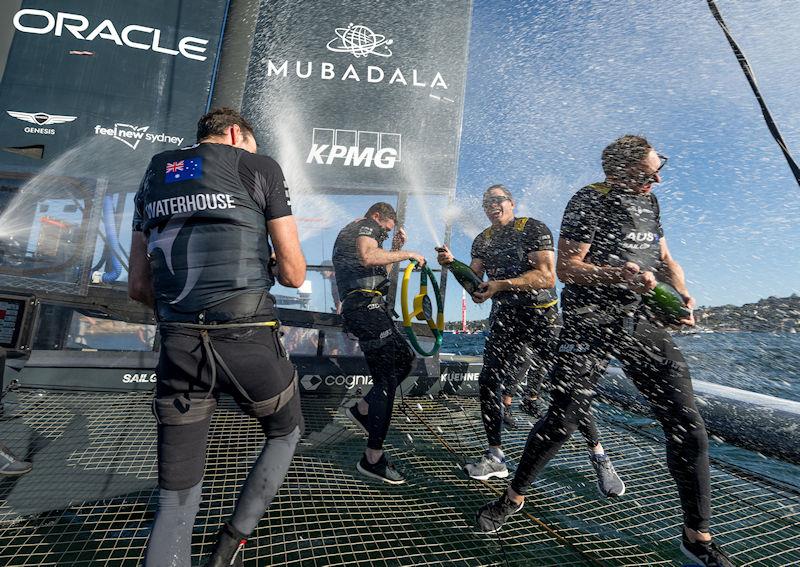 Sam Newton sprays Barons De Rothschild Champagne on team-mates Tom Slingsby, Jason Waterhouse and Kyle Langfordafter they won the KPMG Australia Sail Grand Prix in Sydney, Australia - photo © Ricardo Pinto for SailGP