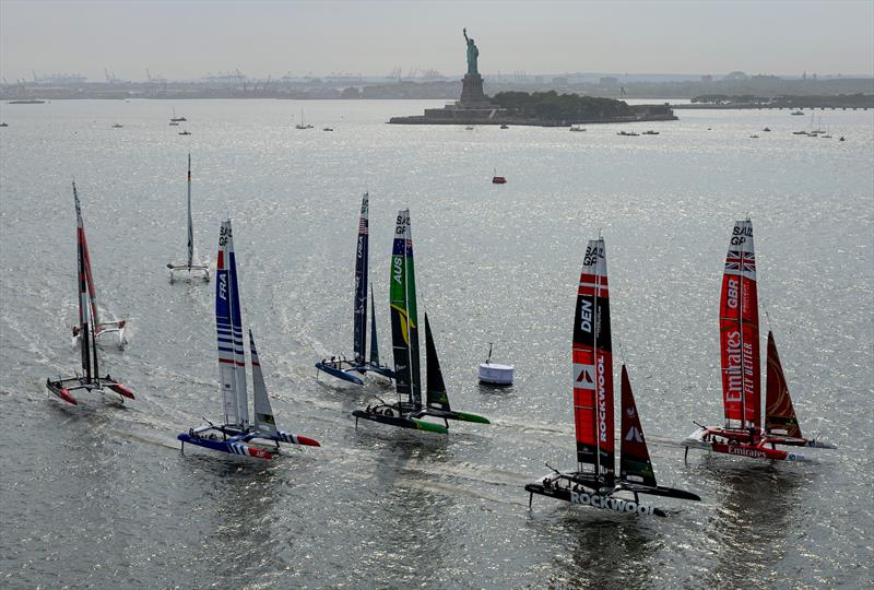 Emirates Great Britain SailGP Team helmed by Giles Scott and ROCKWOOL Denmark SailGP Team helmed by Nicolai Sehested lead the SailGP fleet, with the Statue of Liberty in the background on Race Day 1 of the Mubadala New York Sail Grand Prix - photo © Simon Bruty for SailGP