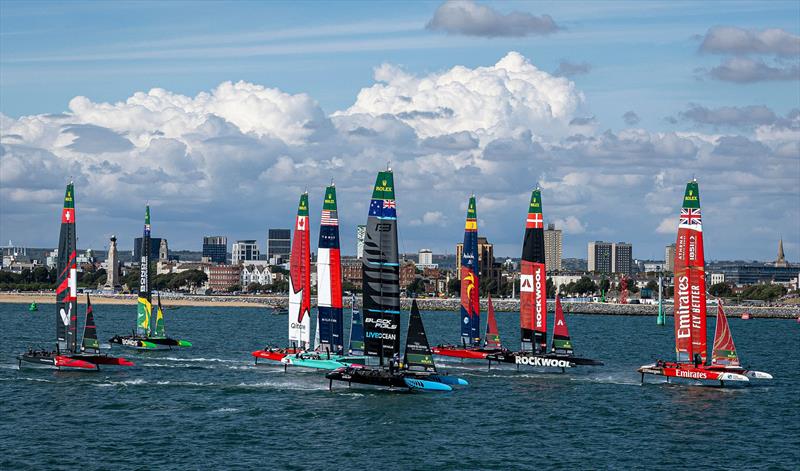 Emirates Great Britain SailGP Team helmed by Dylan Fletcher leads the SailGP F50 catamaran fleet past Portsmouth during Race 1 on Race Day 1 of the Emirates Great Britain Sail Grand Prix in Portsmouth, UK - photo © Simon Bruty for SailGP