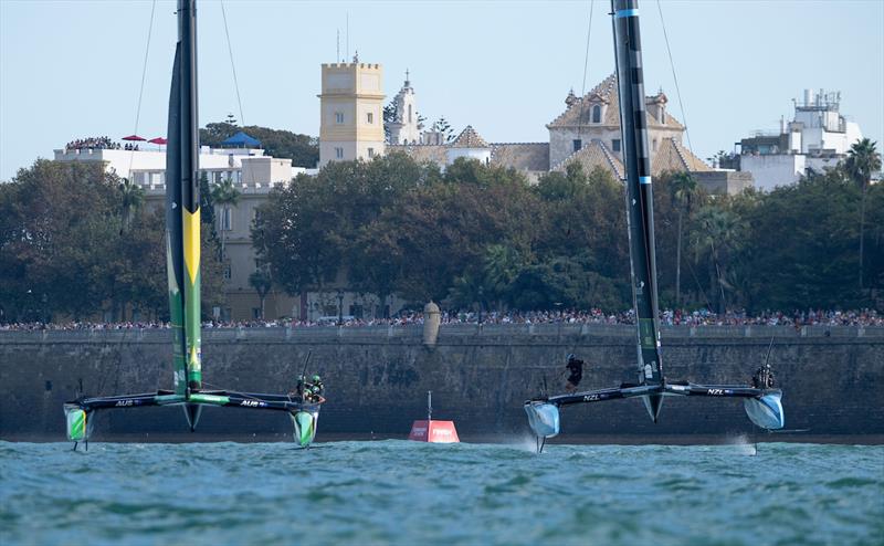 BONDS Flying Roos SailGP Team helmed by Tom Slingsby and New Zealand SailGP Team helmed by Peter Burling race side by side in front of the seawall during racing on Race Day 2 of the DP World Spain Sail Grand Prix held in Cadiz, Spain Sunday 5 October photo copyright Ricardo Pinto for SailGP taken at  and featuring the F50 class