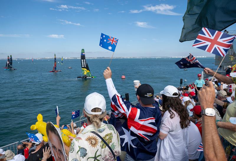 Spectators waving flags in the grandstand as they cheer the BONDS Flying Roos SailGP Team helmed by Tom Slingsby on Race Day 2 of the DP World Spain Sail Grand Prix held in Cadiz, Spain Sunday 5 October photo copyright Jason Ludlow for SailGP taken at  and featuring the F50 class