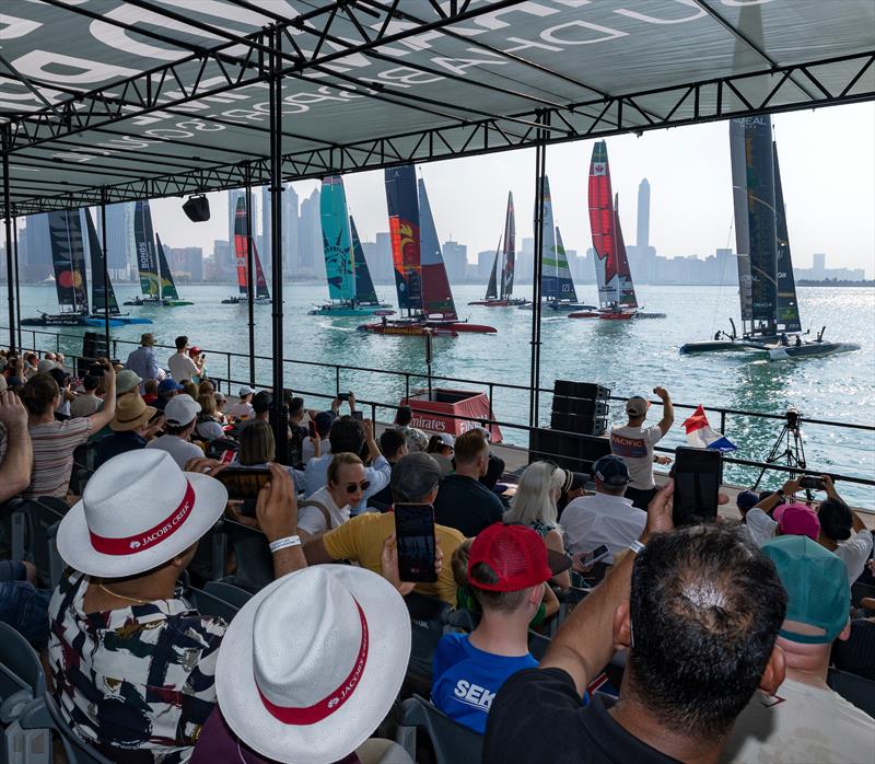 The SailGP F50 catamaran fleet sailing past the Grandstand full of spectators, ahead of Race Day 1, ahead of the Mubadala Abu Dhabi Sail Grand Prix Season Grand Final presented by Abu Dhabi Sports Council - photo © Christopher Pike for SailGP