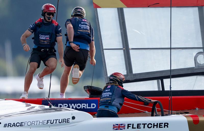 Dylan Fletcher, driver of Emirates Great Britain SailGP Team, and Stuart Bithell, wing trimmer of Emirates Great Britain SailGP Team, cross the boat during a manoeuvre on Race Day 1 of the Switzerland Sail Grand Prix in Geneva, Switzerland photo copyright Jonathan Nackstrand for SailGP taken at  and featuring the F50 class