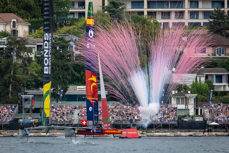Pyrotechnics are released in front of the grandstand as Los Gallos SailGP Team driven by Diego Botin cross the finish line to win the final race ahead of BONDS Flying Roos SailGP Team on Race Day 2 of the Switzerland Sail Grand Prix in Geneva, Switzerland photo copyright Jonathan Nackstrand for SailGP taken at  and featuring the F50 class
