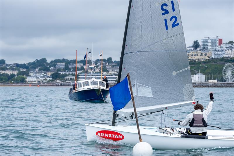 Dan Belton is delighted to see the shortened course flag in Race 4 of the British Finn Nationals at Torbay - photo © Tania Hutchings / www.50northphotography.co.uk