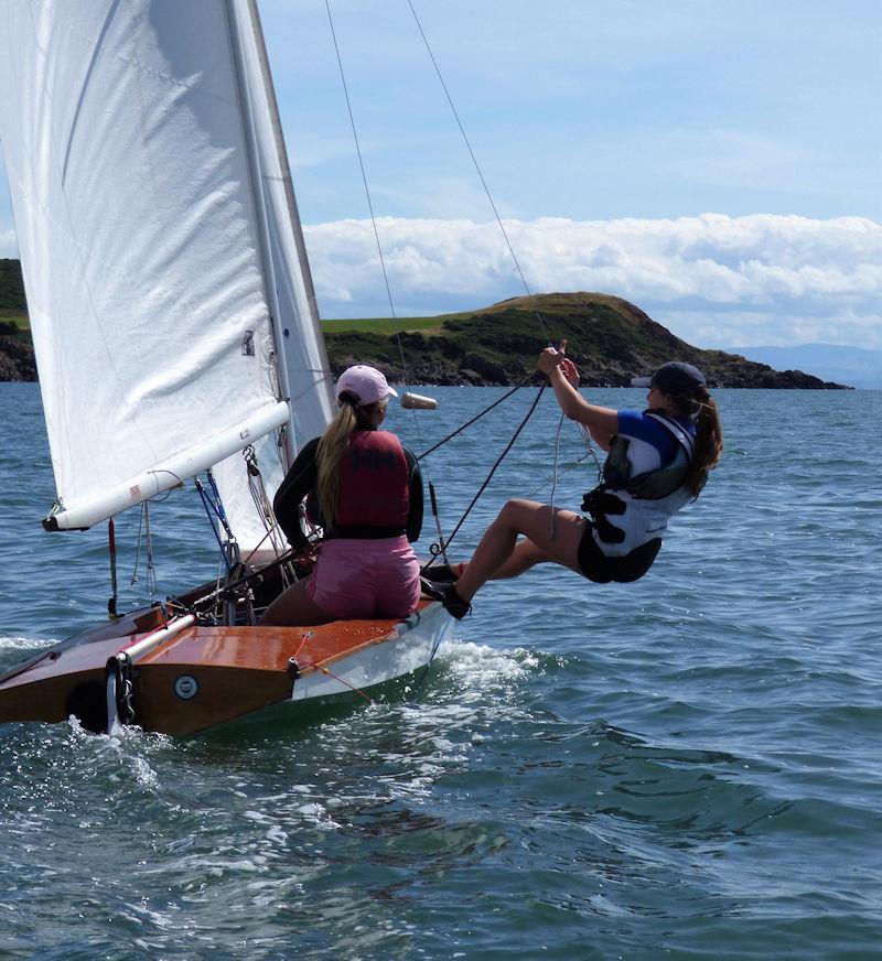 Lilli Bell getting the hang (literally!) of the trapeze on the Fireball while helm, Ellie Rowand keeps things under control during Solway Yacht Club Cadet Week 2022 photo copyright Becky Davison taken at Solway Yacht Club and featuring the Fireball class