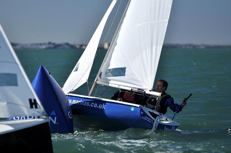 Event organiser Barney Smith sailing with Sam Flint demonstrates how to round the windward mark during the Hamble Warming Pan 2014 - photo © Bertrand Malas