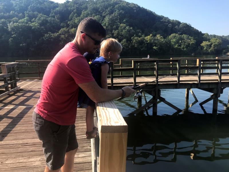 Little girl goes fishing for the first time with her dad from a pier refurbished by union volunteers - photo © Union Sportsmen’s Alliance