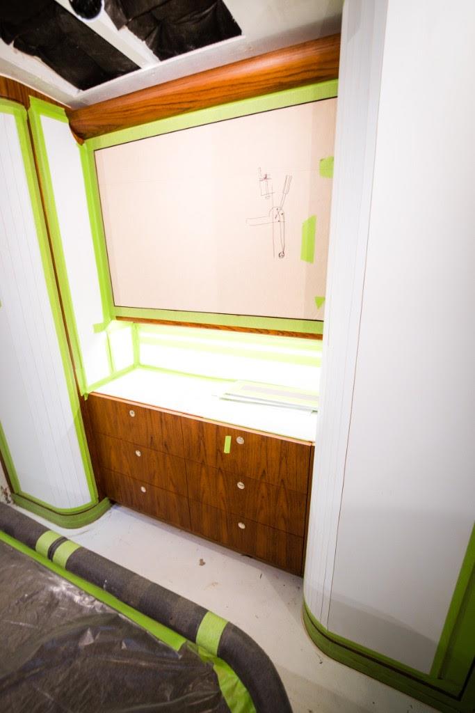 Master stateroom TV cabinet/dresser, and tackle room cabinet and floor installation progress - photo © John Bayliss