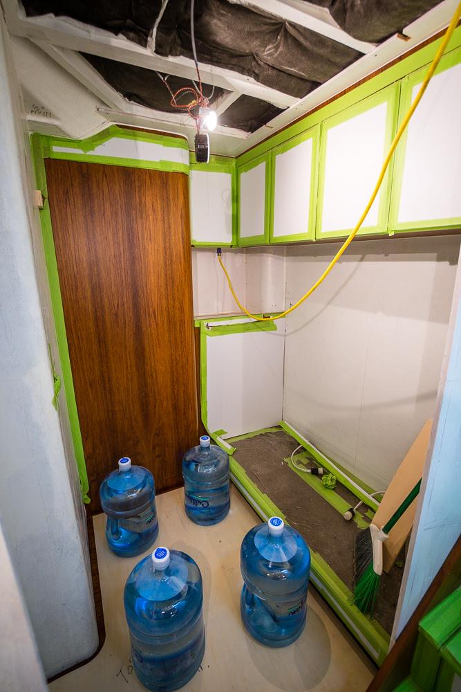 Master stateroom TV cabinet/dresser, and tackle room cabinet and floor installation progress - photo © John Bayliss