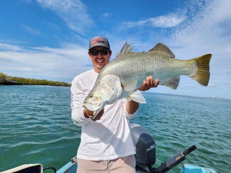 Tommy with a solid barra he managed to tempt, even during these cold temps - photo © Fisho's Tackle World