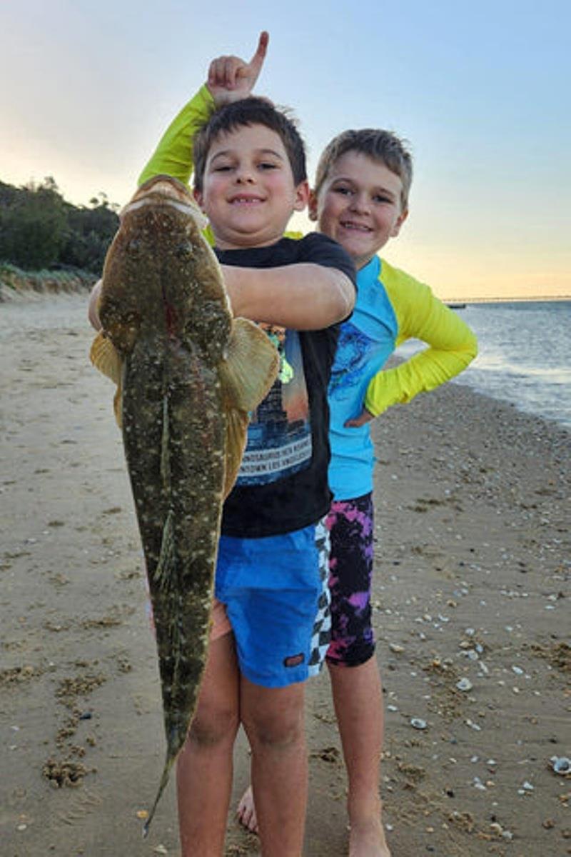 The Johnston boys proudly displaying their ripper flattie caught from the beach at Urangan recently. Well done lads - photo © Fisho's Tackle World