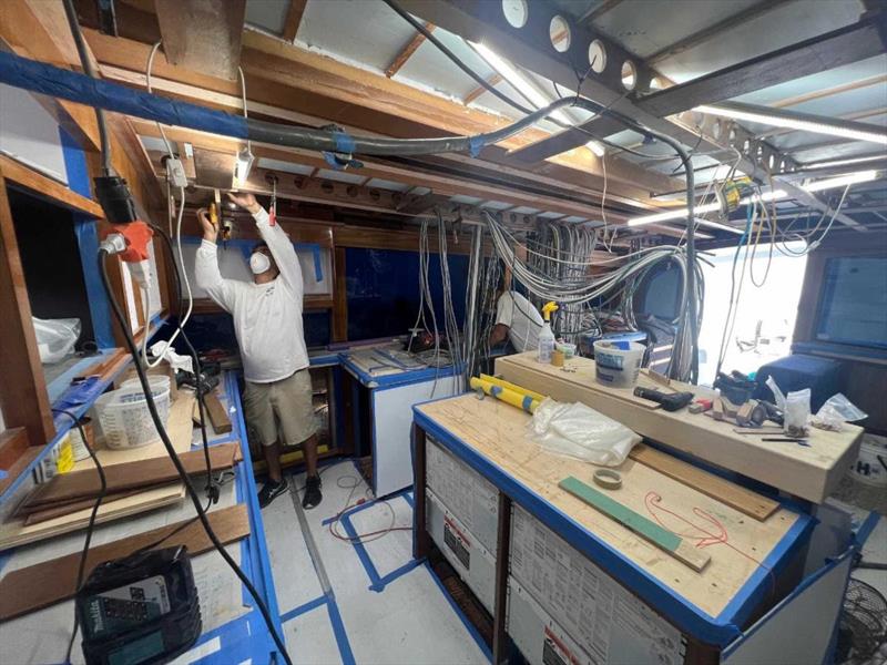 Hull #9 - Vince installing light boards - photo © Michael Rybovich & Sons
