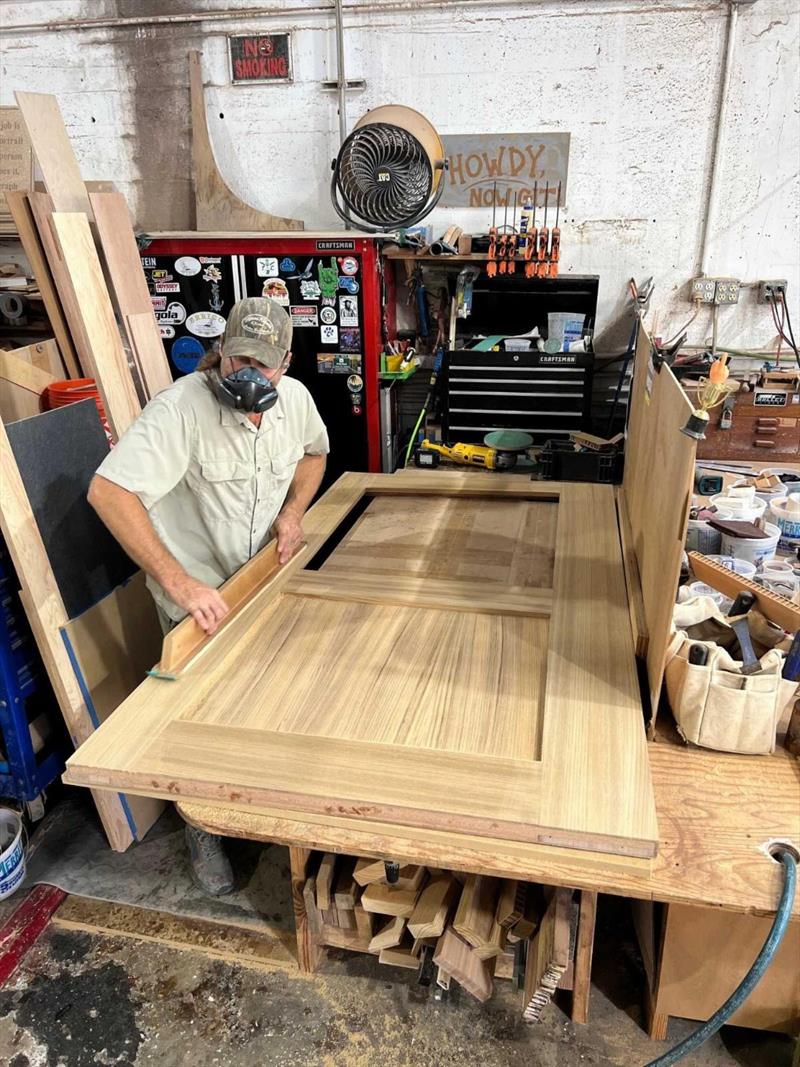 Hull #9 - Paul veneering salon door - photo © Michael Rybovich & Sons