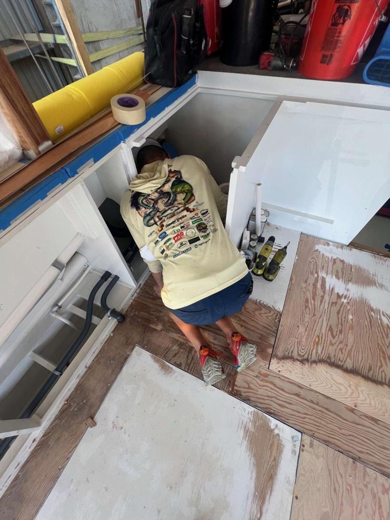 Hull #10 - Craig installing AC and ice machine - photo © Michael Rybovich & Sons