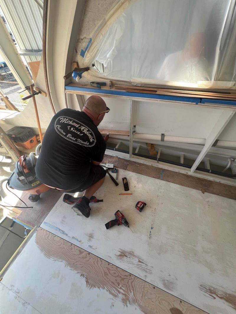 Hull #10 - Chris F installing starboard wireways - photo © Michael Rybovich & Sons