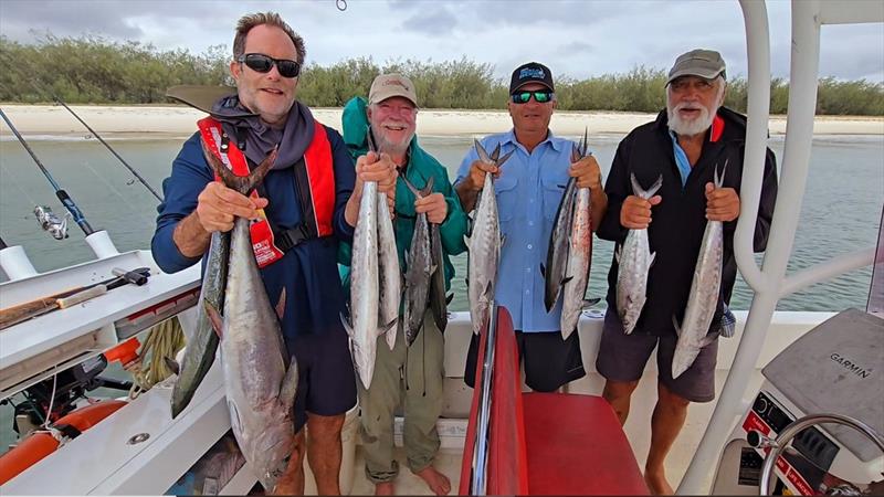 Hot Reels Charter clients with a feed of schoolies and a solo longtail - photo © Fisho's Tackle World