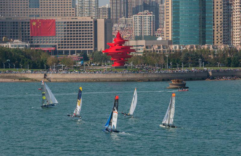 The fleet sailed 10 races against the backdrop of Qingdao's May Fourth Square - Day 3 - Extreme Sailing Series Qingdao Mazarin Cup photo copyright Patrick Condy taken at  and featuring the Flying Phantom class