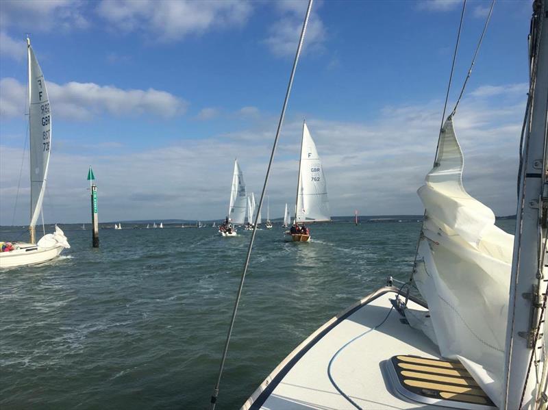 Folkboats head out for the start of Moore Blatch & Station Financial Lymington Thursday Night Series race 5 photo copyright RLYC taken at Royal Lymington Yacht Club and featuring the Folkboat class