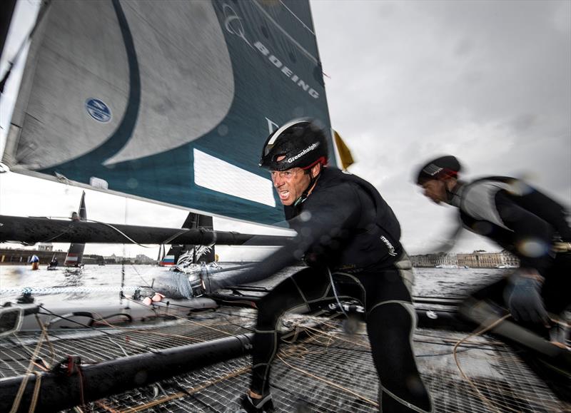 Oman Air's mainsail trimmer, Pete Greenhalgh, hard at work on day 4 of Extreme Sailing Series™ Act 5, St Petersburg photo copyright Lloyd Images taken at  and featuring the GC32 class