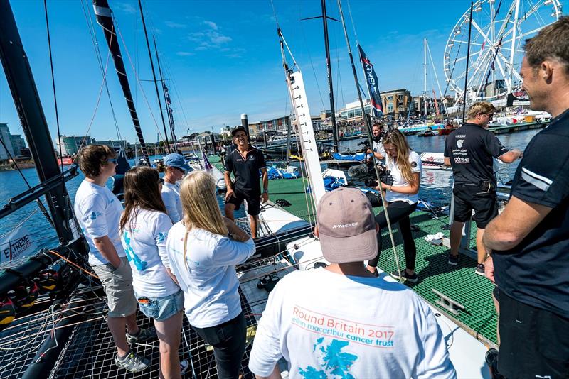 Team Oman Sail show the EMCT crew around their GC32 at the Extreme Sailing Series photo copyright Ellen MacArthur Cancer Trust taken at  and featuring the GC32 class