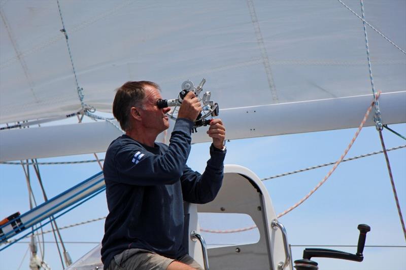 Tapio taking advantage of the clear skies to take a Noon sun sight - Golden Globe Race - photo © Peter Foerthmann / Windpilot and Les Gallagher / Fishpics / PPL