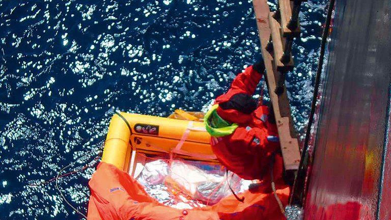 Tapio Lehtinen climbs onboard the Hong Kong-flagged bulk carrier Darya Gayatri after spending 24 hours at sea in his liferaft - photo © Anglo Eastern