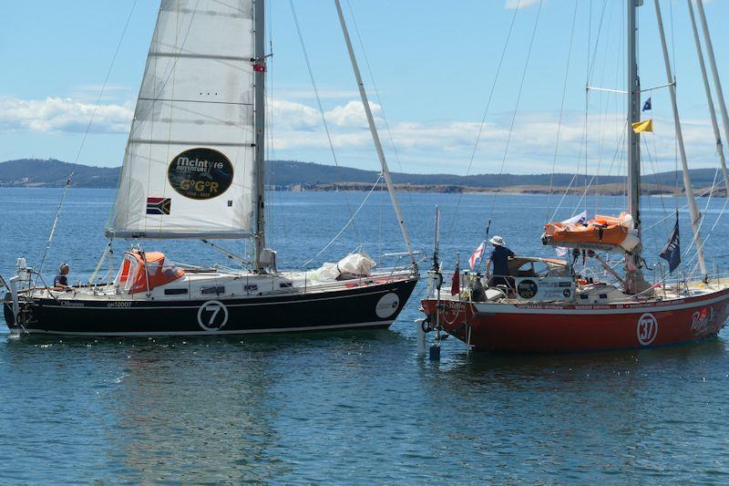 Jeremy Bagshaw sails past Ian Herbert Jones whilst still at anchor, to say goodbye - Golden Globe Race (January 2023) photo copyright Jackie Zanetti / Alex Papij (Rusalka) / GGR2022 taken at  and featuring the Golden Globe Race class