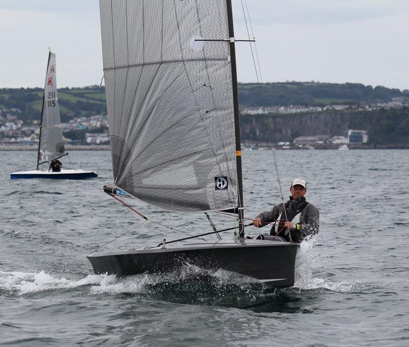 Ian Sanderson crosses the finish line in race 1 on day 1 of the Hadron H2 Nationals in Torbay photo copyright Keith Callaghan taken at Royal Torbay Yacht Club and featuring the Hadron H2 class