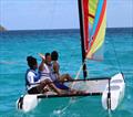 Althea Auguiste (far left) and her family, Augustina Auguiste (center) and Gregory Auguiste (right) on a Hobie Wave © STSC / C. Bareuther