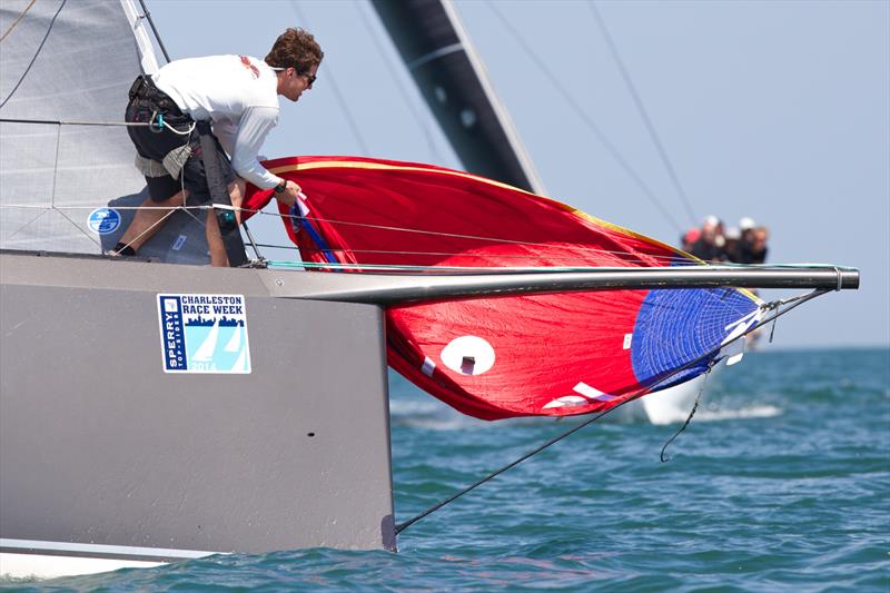 A bowman on the fastest boat on the course - the 47-foot GrunDOOM - hauls the spinnaker to the bow to prepare for a hoist on day 1 at 2014 Sperry-Top Sider Charleston Race Week photo copyright Meredith Block / 2014 Sperry-Top Sider Charleston Race Week taken at Charleston Yacht Club and featuring the HPR class