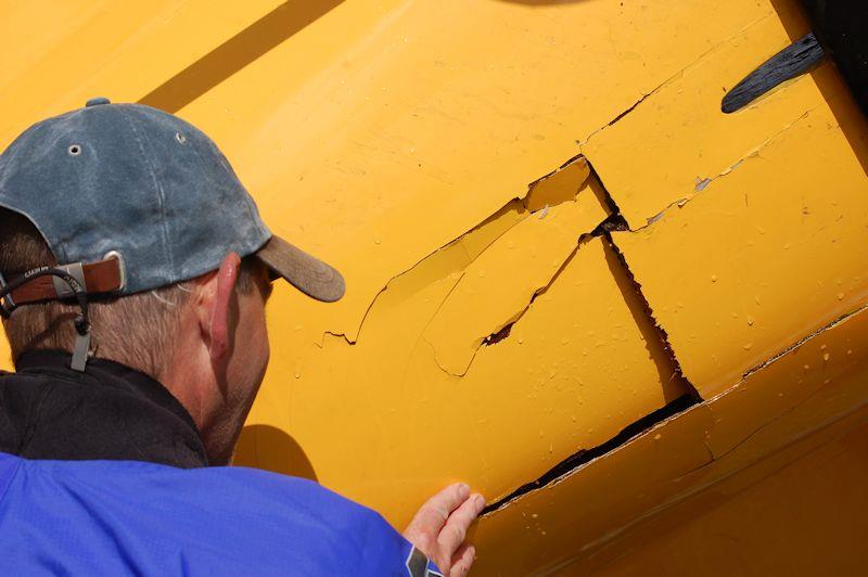 In the days before carbon fibre, tortured ply offered boat builders a relatively inexpensive route to a stiff, lightweight hull... but it doesn't withstand impact very well, such as a tumbling helm following a cartwheel capsize! photo copyright David Henshall taken at  and featuring the International Moth class