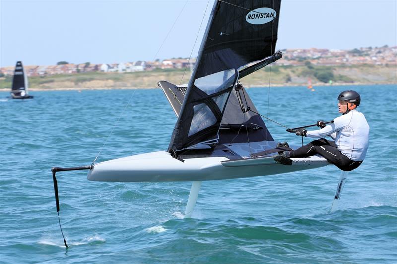 Wetsuit Outlet International Moth UK Nationals at the WPNSA Day 4 - GBR 4990 Jason Belben finishes Race 10 photo copyright Mark Jardine taken at Weymouth & Portland National Sailing Academy and featuring the International Moth class