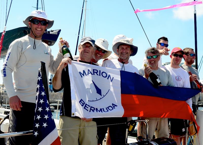 John Levinson (centre) and crew show off their Line Honours banner at the Royal Hamilton Amateur Dinghy Club. ‘Jambi', a new Hinckley Bermuda 50 crossed the finish line off St. David's Lighthouse at 12:47:00 ADT photo copyright Talbot Wilson taken at Royal Hamilton Amateur Dinghy Club and featuring the IRC class