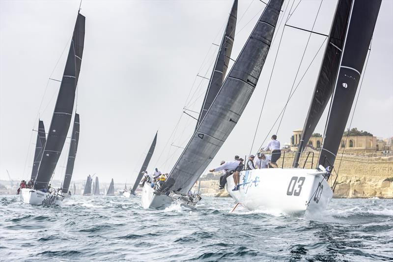 Ino XXX leads her nearest rivals out of Grand Harbour following the start of the 42nd edition of the 2021 Rolex Middle Sea Race photo copyright Kurt Arrigo / Rolex taken at Royal Malta Yacht Club and featuring the IRC class