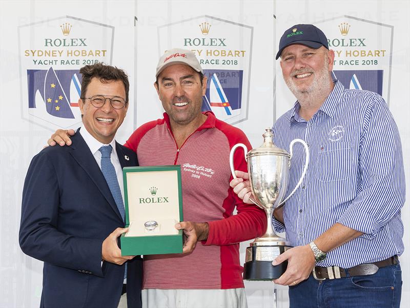 Patrick Boutellier (L), General Manager of Rolex Australia, and Paul Billingham (R), Commodore of the CYCA, Present Line Honours Winner Mark Richards, Skipper of Wild Oats XI, with a Rolex Timepiece and the John H Illingworth Challenge Cup - RSHYR 2018 - photo © Rolex / Studio Borlenghi