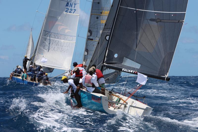 Showing great sportsmanship and camaraderie: Joshua Daniels, keelboat instructor at the National Sailing Academy with his young crew on NSA Valiant - Antigua Sailing Week - photo © Tim Wright / www.photoaction.com